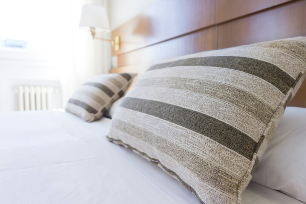 Striped shams outfit a brightly lit room for a luxurious hotel staycation